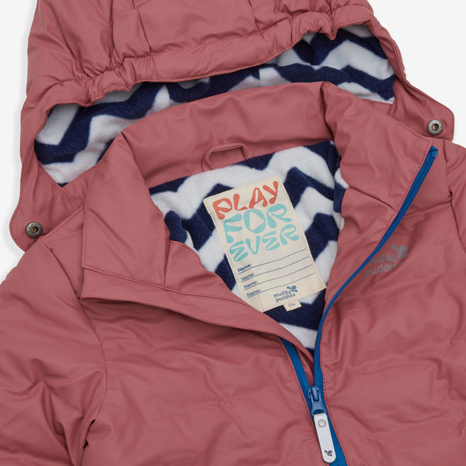 A close up of the Waterproof Puffer Jacket in pink, showing the label and the zigzag pattern of the hood lining.